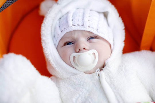 Portrait Of Adorable Newborn Baby In Warm Winter Clothes