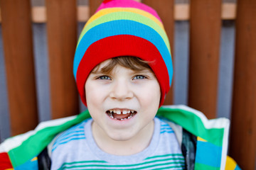 Outdoor fashion portrait of adorable little kid boy wearing colorful clothes