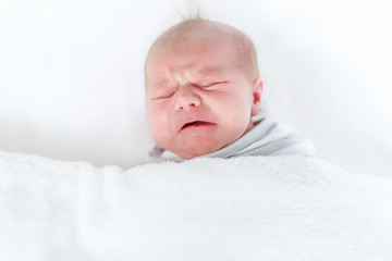 Portrait of cute adorable newborn baby child crying