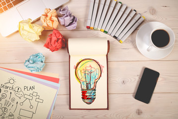 Light bulb in a notebook, smartphone