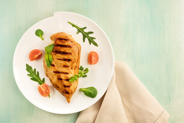 Grilled chicken fillet with cherry tomatoes and salad leaves