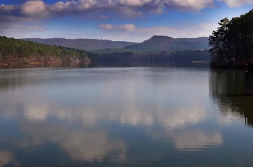 Foto op Canvas Mountain Lake kalm water reflectie met wolken en blauwe lucht wijd schot © Bowden Creative