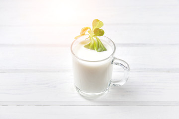 A Cup of yogurt on a white table.