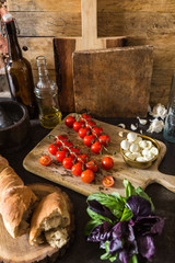 Composition of cherries, mozzarella and french bread on vintage background