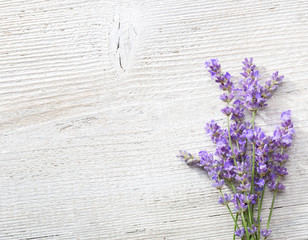 Few sprigs of lavender on an old wooden background