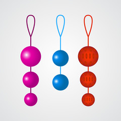 Set of colorful vaginal balls on a grey background.