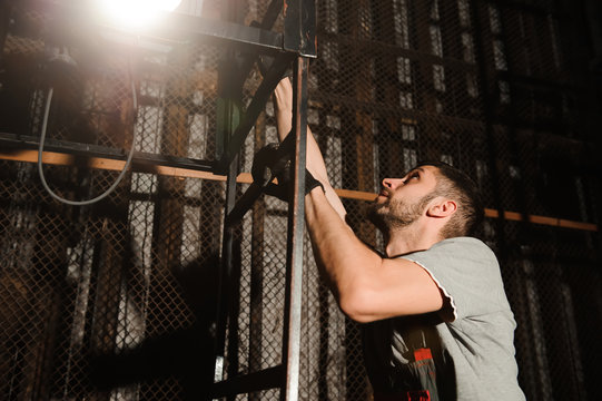 The lighting engineer adjusts the lights on stage behind the scenes