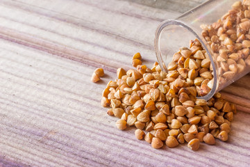 Seeds  scattered from a jar on a gray board lie slide