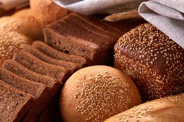 Assortement of Freshly baked traditional bread with ears of wheat and white cloth