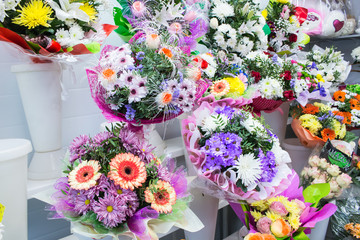 bunches of big fresh orange pink red gerbera chamomile and big white yellow blue chrysanthemum flower