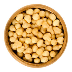 Fried batter pearls in a wooden bowl. Crispy pearls. A soup topping and snack product made from flour, vegetable fat and yeast. Isolated macro food photo close up from above on white background.