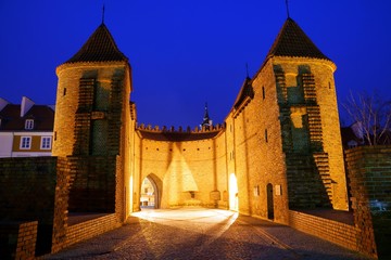 Night view at Barbican fortress (castle) in old town Warsaw, Poland