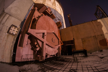 Red steel hermetic door of reactor abandoned power unit of nuclear power plant
