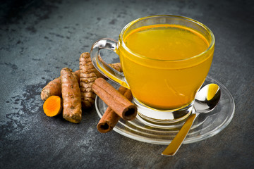 herbal tea with turmeric powder,slices and cinnamon