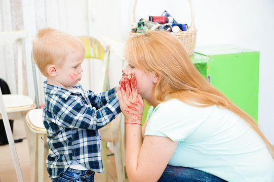 Mother and child draw a picture paints, art lesson