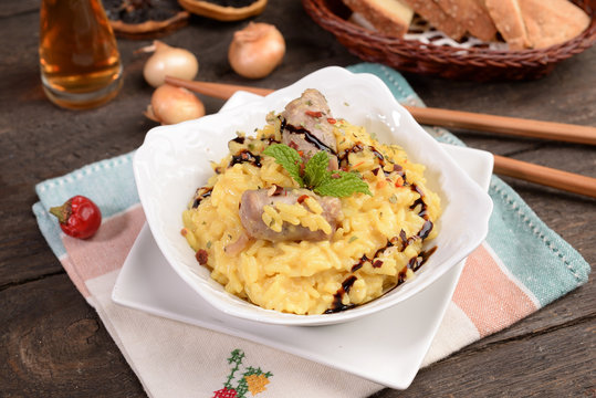 Bowl of saffron rice with sausage and wine