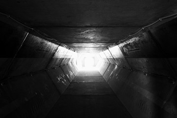 Light at the end of tunnel black and white,square concrete tunnel,Perspective View Through a Dark Tunnel With the Light at The End