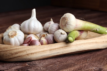 Garlic. Garlic Cloves and Garlic Bulb in vintage wooden bowl.