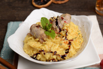Bowl of saffron rice with sausage and wine