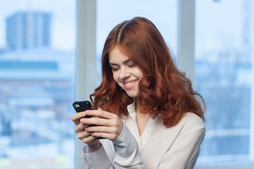 a woman is driving a finger on the touch phone