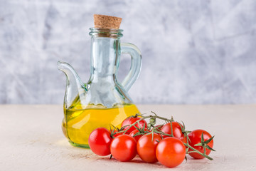 Bottle with vegetable oil and cherry tomatoes