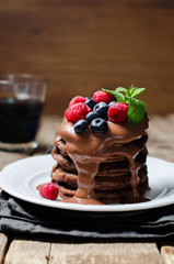 chocolate pancake with blueberries, raspberies and chocolate sauce
