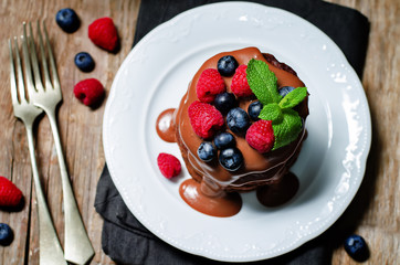 chocolate pancake with blueberries, raspberies and chocolate sauce