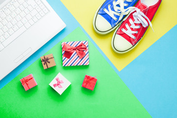 cute gifts, gumshoes and silver laptop on the wonderful colorful  background in pop art style
