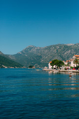 Fototapeta na wymiar The old town of Perast on the shore of Kotor Bay, Montenegro. The ancient architecture of the Adriatic and the Balkans. Fishermen's cities of Europe.