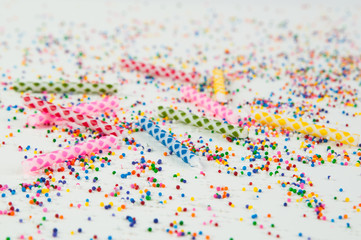Fototapeta na wymiar colorful birthday candles and candy sprinkles