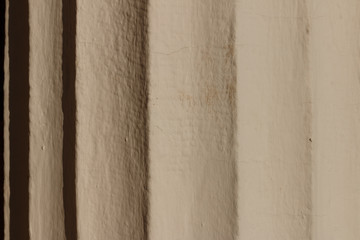Fragment of the column with flutes. Bright sun reveals details. Monuments with pillars. Classic...