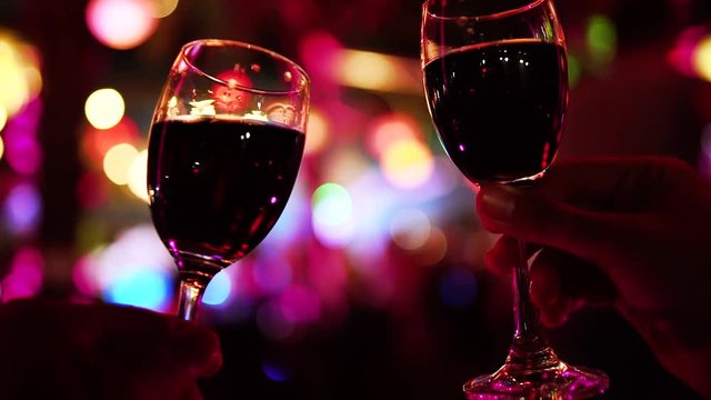 Two People Cheers or Toast Red Wine Glasses Clinking. Holiday Celebration Concept.