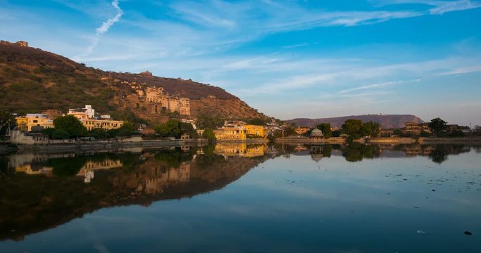 Bundi cityscape from sunset to night. The majestic city palace and Tara fort reflected on lake. Travel destination in Rajasthan, India. Time lapse.