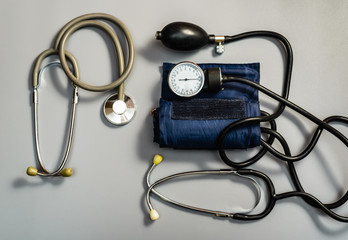 Medical instruments: stethoscope and tonometer.