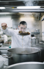 Chinese cook preparing stew in the pan