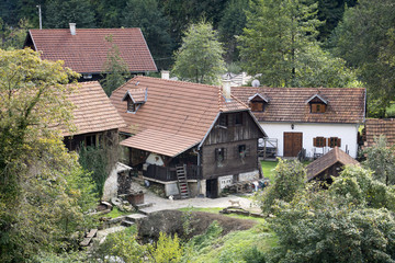 Fototapeta na wymiar Rastoke, a picturesque village in Craotia woth wooden houses and waterfalls