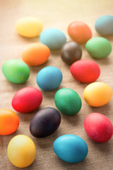 Multicolored easter eggs on a cloth background. The concept of a holiday and a happy Easter.