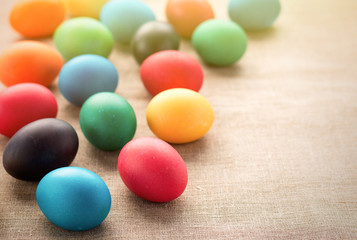 Multicolored easter eggs on a cloth background. The concept of a holiday and a happy Easter. With space for text