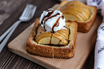 Baked apples with toast and ice cream on a rustic background