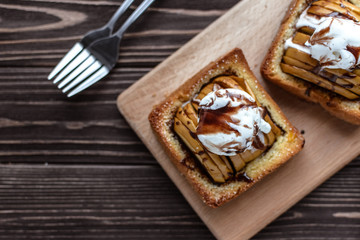 Baked apples with toast and ice cream on a rustic background