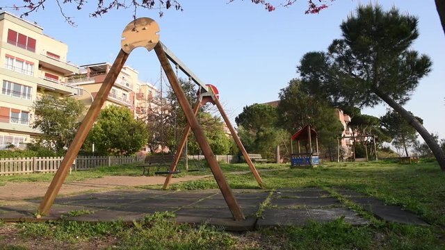 Empty kid garden park and urban background at sunset light, symbol of childhood