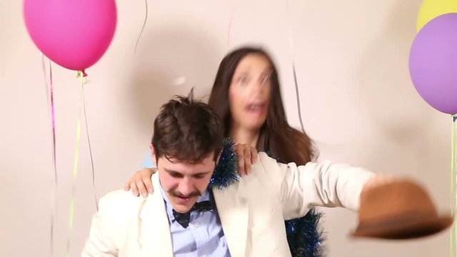 Funny couple fainting from too much dancing in party photo booth