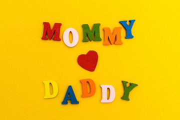 Red heart on a yellow background, Mom loves Daddy.
