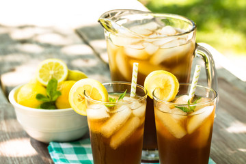 Iced Tea With Lemon and Mint On Picnic Table