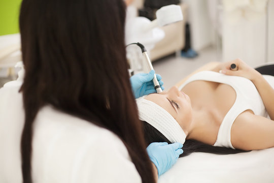 Body Care. Woman Receiving Face Skin Analysis. Cosmetology