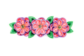 Kanzashi. Violet artificial flowers isolated on white background.