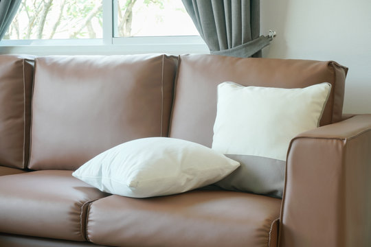 Close up pillows on brown leather sofa
