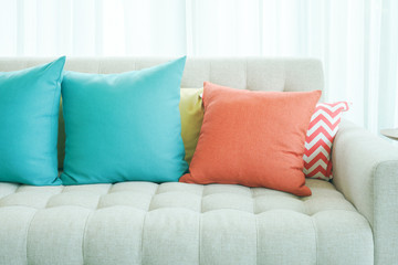 Green and orange pillows on sofa in modern style living room