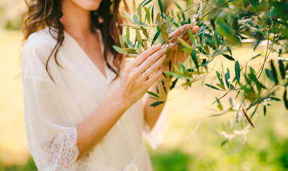 Olive branch in female hands. Hands of the bride. Wedding in Montenegro