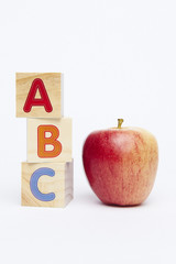 ABC Spelling toy blocks with apple on white background